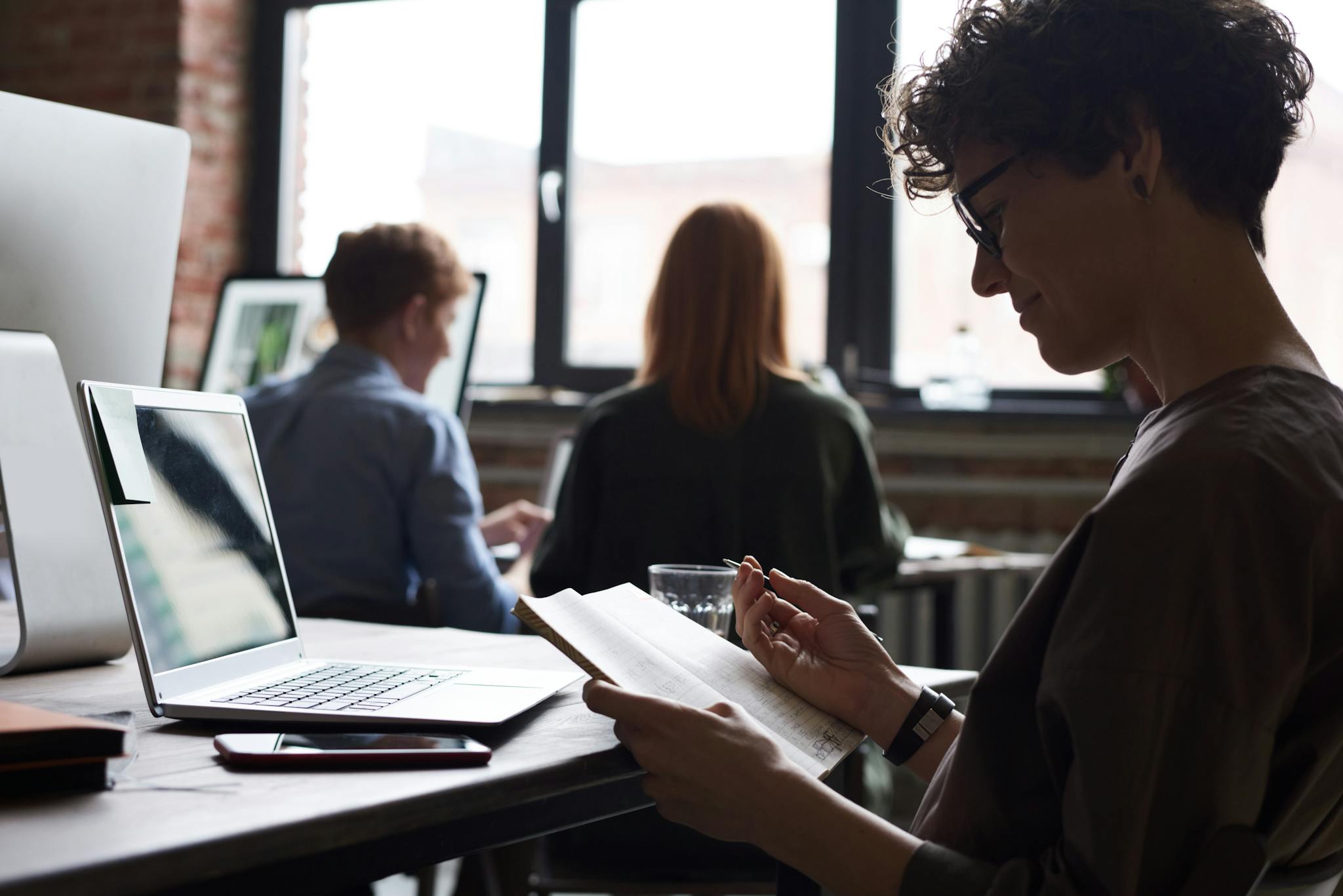 A group of colleagues working together in a modern office setting.